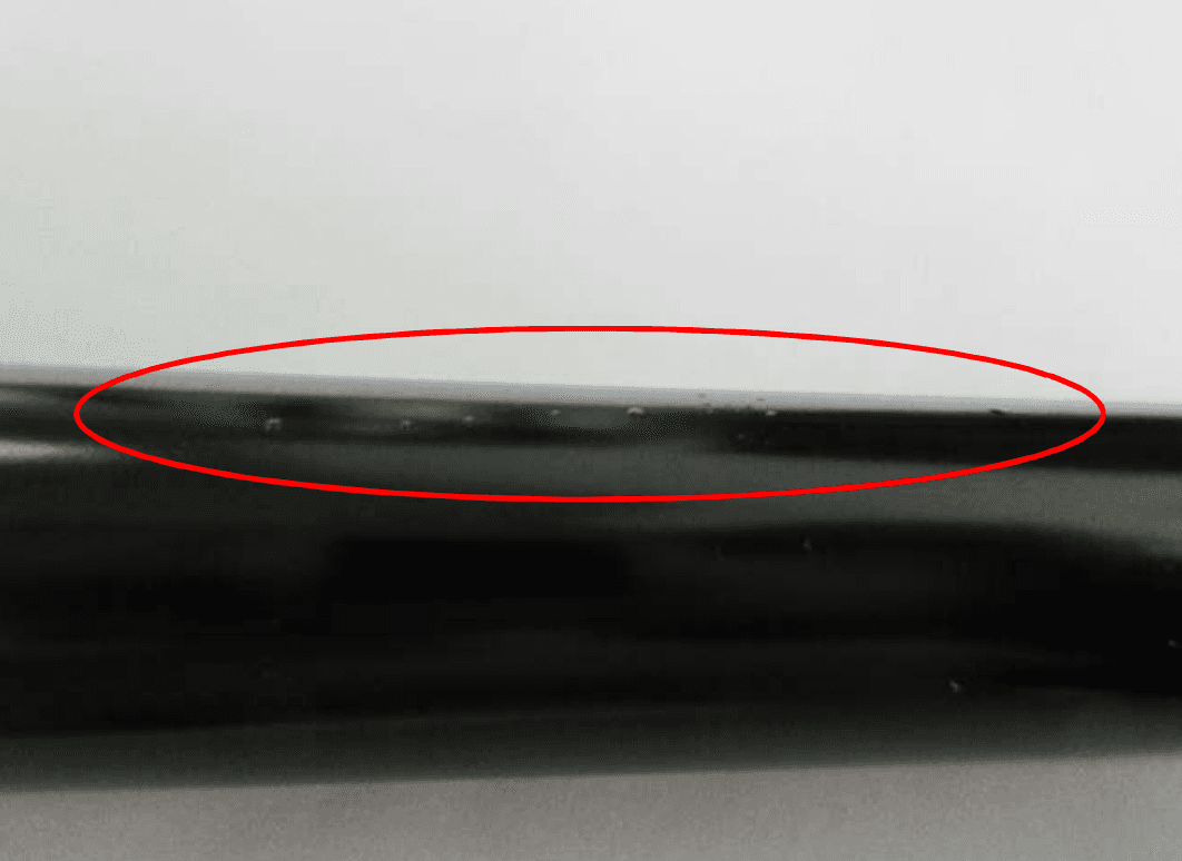 Close-up of DK gas spring QPQ piston rod surface after 96h salt spray test showing no red rust
